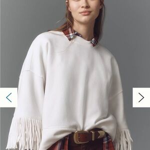 Anthropologie Maeve white sweatshirt with fringe sleeves.